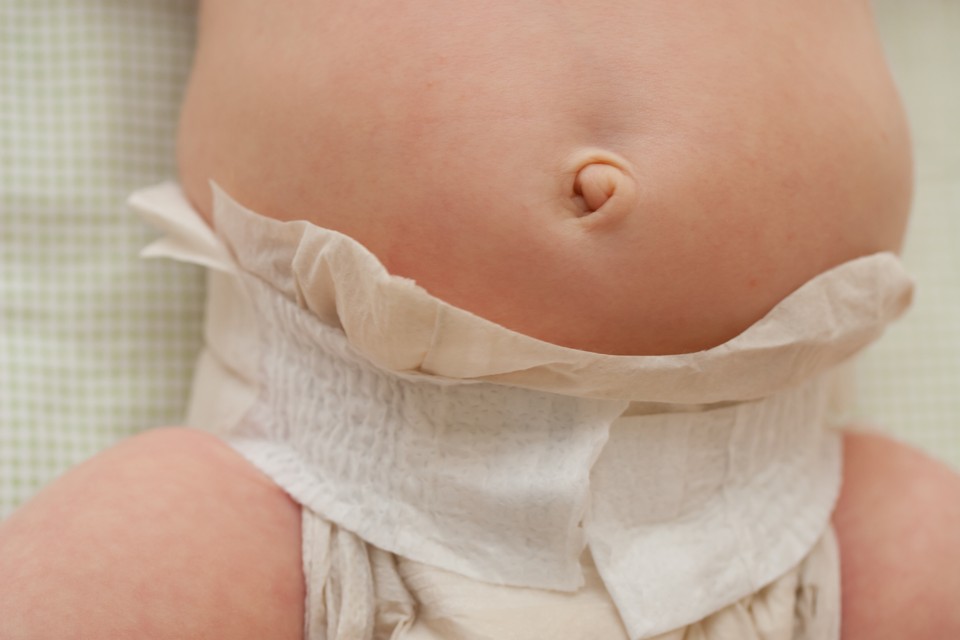 A photograph of a baby wearing a diaper. Jerome Scholler / Shutterstock